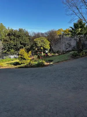 a brick driveway with a garden in the background at Garden Studio 2 Waterkloof Ridge in Pretoria