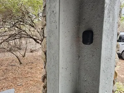 a stone wall with a black button on it at Kruger Amani Bush Retreat in Marloth Park