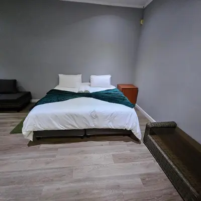 a bedroom with a bed with white sheets and pillows at Da Vinci Palms in Witbank