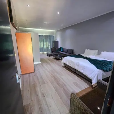 a hotel room with a bed and a couch at Da Vinci Palms in Witbank