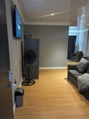 a living room with a couch and a flat screen tv at Da Vinci Palms in Witbank