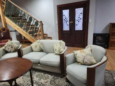 a living room with two chairs and a table at Verloren Lodge in Modimolle
