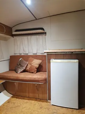 a small bed in the back of an rv at Hartbeespoort Cara-glamping self-cater units in Pretoria