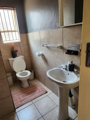 a bathroom with a toilet and a sink at Pearl palace in Polokwane