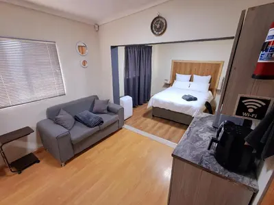 a living room with a couch and a bed at 26onMagazyn in Polokwane