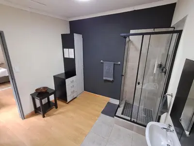 a bathroom with a shower and a sink at 26onMagazyn in Polokwane