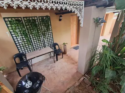 a patio with a table and two chairs at 26onMagazyn in Polokwane