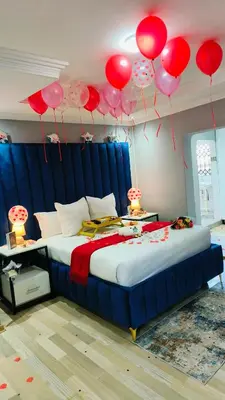 a bedroom with a bed with red and pink balloons at The greenary guest house and restaurant in Thohoyandou