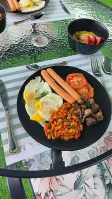 a plate of food with carrots and beans on a table at The greenary guest house and restaurant in Thohoyandou