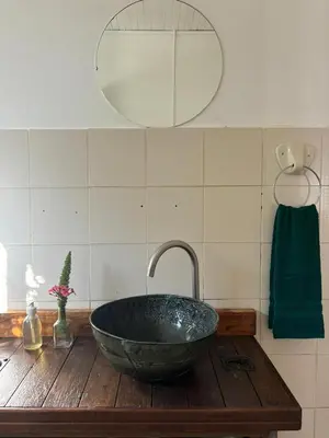 a bathroom sink with a large stone bowl at The Seed Pod Guesthouse in Haningfontein
