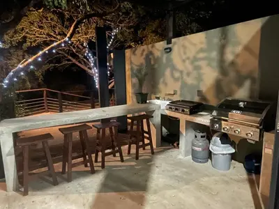 a patio with a table and chairs and a grill at Idyllic Kruger Breeze Marloth Park - 4 Bedroom in Marloth Park