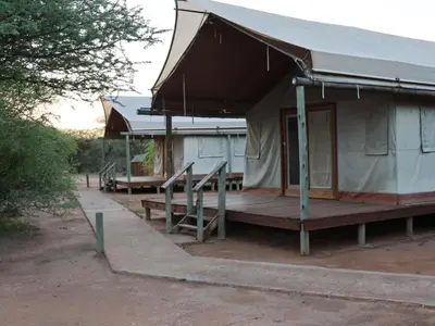 a building with a porch and a tent at Ngata Safari Lodge in Hammanskraal