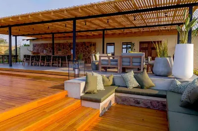 an outdoor patio with a couch and a table at Umlingo Lodge in Melkrivier