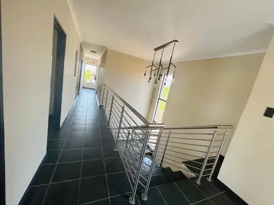 a staircase in a house with a metal railing at Chill Out in Malelane