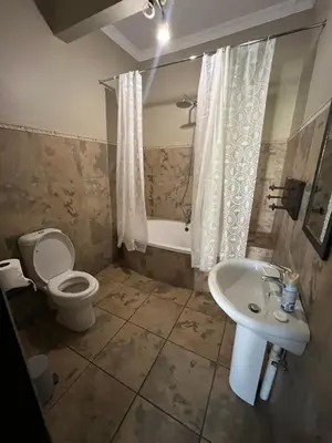 a bathroom with a toilet and a sink at Toshari BnB in Musina