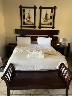 a bedroom with a large bed with a boat on it at Toshari BnB in Musina