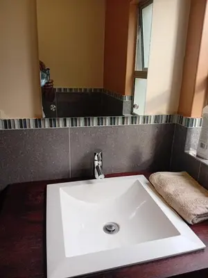 a white sink in a bathroom with a mirror at 4C On Gillian in Sandton