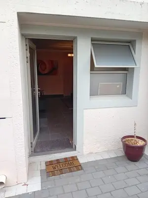 an open door with a welcome mat in front of a house at 4C On Gillian in Sandton