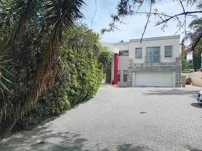a white house with a red door and a driveway at 4C On Gillian in Sandton