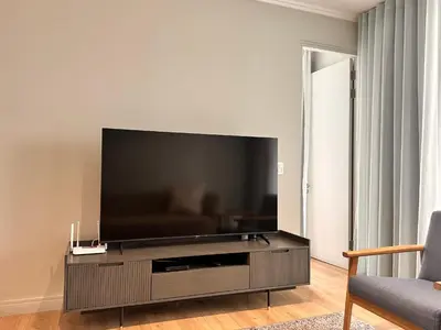 a living room with a large flat screen tv at 2115 Kepler, Ellipse - Serene Luxury in Midrand