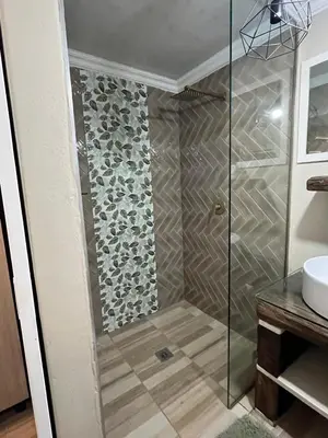 a shower with a glass door in a bathroom at Galpinii House in Pretoria