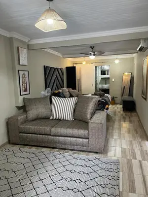 a living room with a couch in a room at Galpinii House in Pretoria