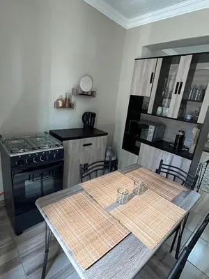 a kitchen with a table with chairs and a stove at Galpinii House in Pretoria