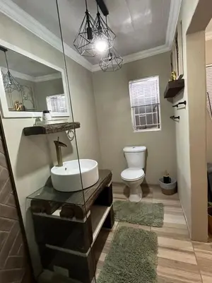 a bathroom with a sink and a toilet at Galpinii House in Pretoria