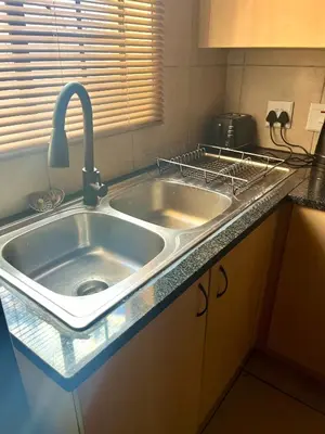 a kitchen sink with a faucet on top of it at 2 Spacious bedroom apartment in Ellisras