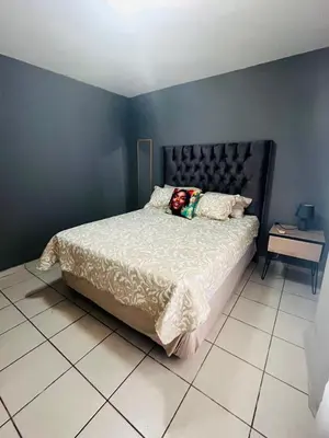 a bedroom with a bed with a person laying on it at 2 Spacious bedroom apartment in Ellisras