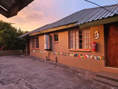 a small house with a sign on the side of it at Malala Lodge in Lorraine