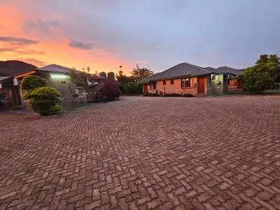 a brick driveway in front of a house at Malala Lodge in Lorraine