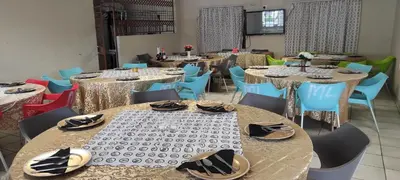 a dining room with tables and chairs with shoes on them at Malala Lodge in Lorraine