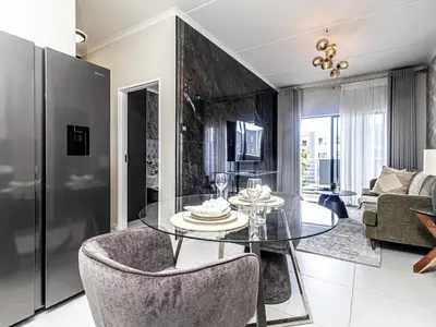 a dining room with a glass table and chairs at Binbin Home Away From Home in Midrand
