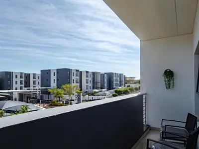 a balcony with a view of a city at Binbin Home Away From Home in Midrand