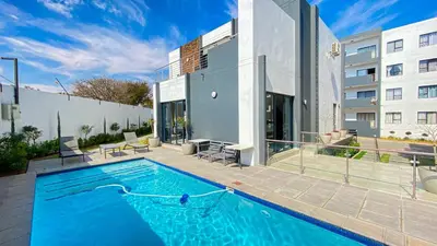 a swimming pool in front of a building at Binbin Home Away From Home in Midrand