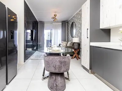 a kitchen and living room with a table and a couch at Binbin Home Away From Home in Midrand