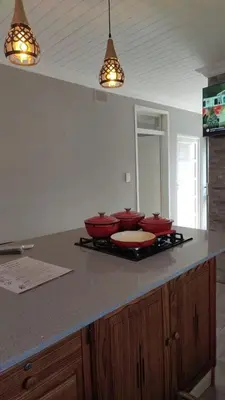 a kitchen with three red bowls on a counter at Tabularasa Hideaway in Pretoria