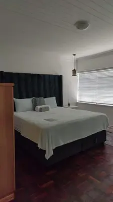 a bedroom with a large bed in a room at Tabularasa Hideaway in Pretoria