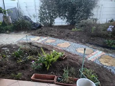 a garden with rocks and plants in the dirt at Tabularasa Hideaway in Pretoria