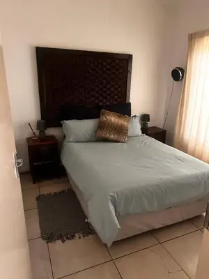 a bedroom with a large bed with a headboard at 49 Bela-Bela Pendleberry Grove Holiday Unit 49 in Warmbaths