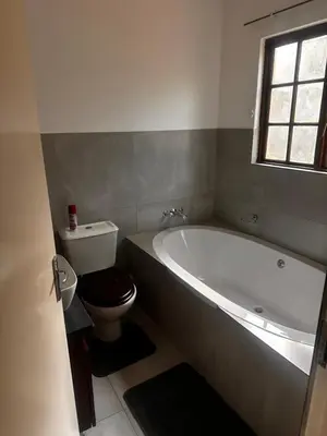 a bathroom with a bath tub and a toilet at 49 Bela-Bela Pendleberry Grove Holiday Unit 49 in Warmbaths