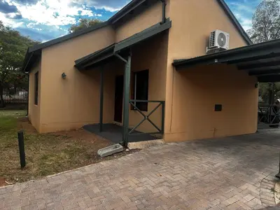 a building with an open garage with an open door at 49 Bela-Bela Pendleberry Grove Holiday Unit 49 in Warmbaths