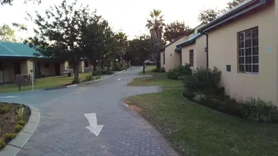 an empty street next to a building with an arrow on it at 49 Bela-Bela Pendleberry Grove Holiday Unit 49 in Warmbaths