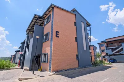 a brick building on a street at Ridge Comfort in Midrand