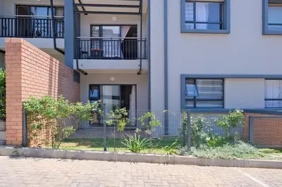 an apartment building with a fence in front of it at Ridge Comfort in Midrand