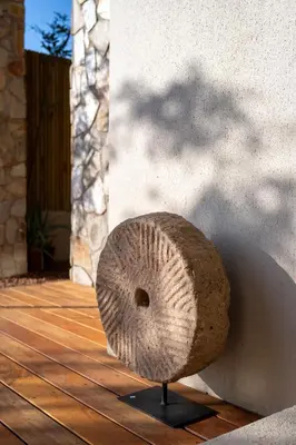 a rock sitting on top of a wooden deck at Khiwane Boutique Hotel in Hoedspruit