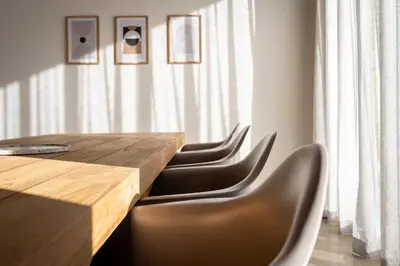 a wooden table and chairs in a room at Khiwane Boutique Hotel in Hoedspruit