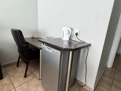 a table with a phone on it next to a desk at Bobisemo Luxury Guesthouse in Tierpoort