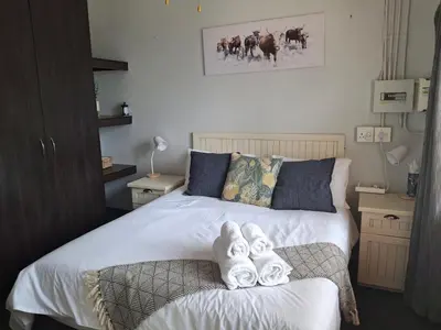a bedroom with a bed with towels on it at Meander Sky in Centurion